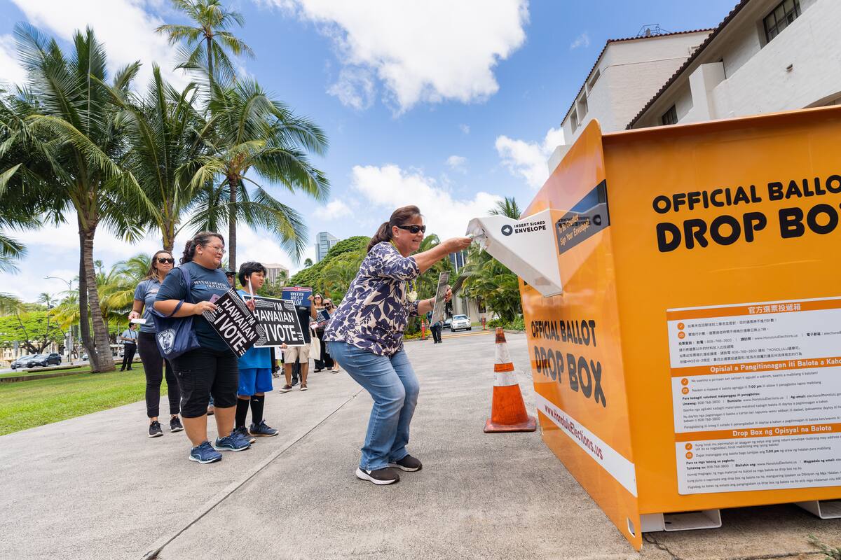 Walk to the Box participant posing beside the ballot drop box